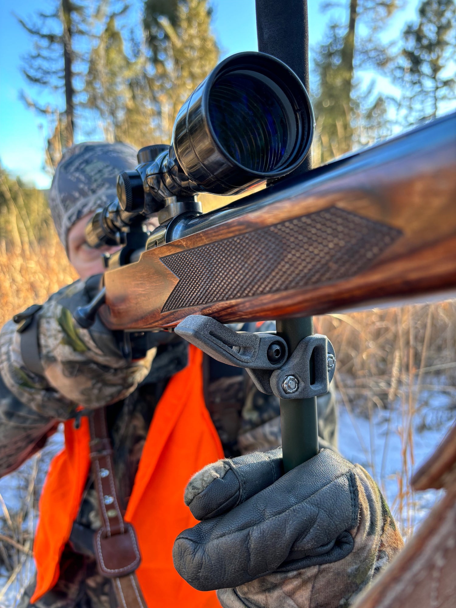 A hunter using the roadrunner rifle rest attached to a trekking pole to stabilize a rifle.