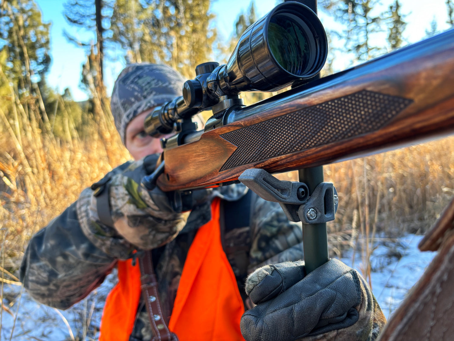 A hunter using the roadrunner rifle rest attached to a trekking pole to stabilize a rifle.